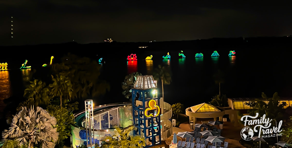 The dragon floats from the Electrical Water Pageant with the Bay Lake pool in the foreground 
