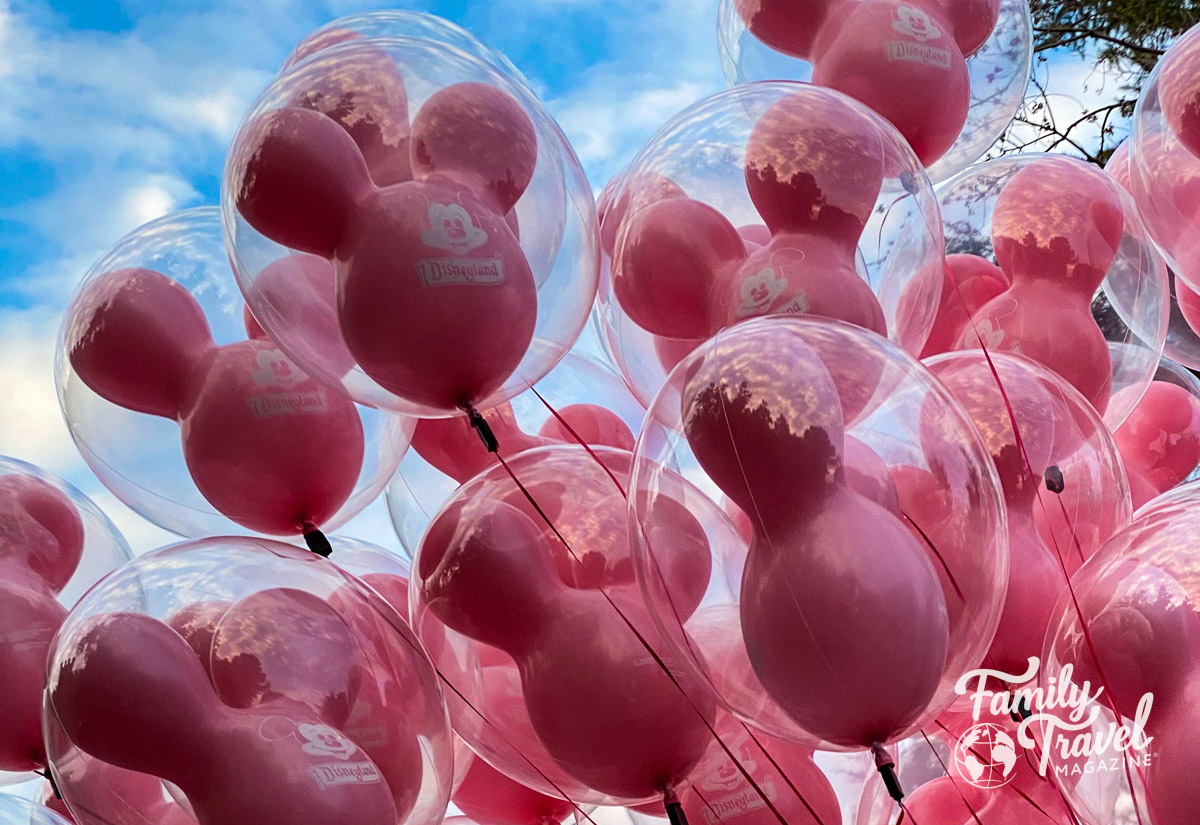 Pink Mickey balloons in the sky - "how many days in Disneyland"?