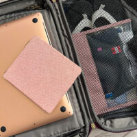 open, small packed bag with eReader, and laptop on top - convention packing tips
