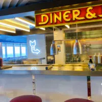 Diner and Dash counter with grill and counter stools - one of the Virgin Voyages restaurants