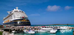 The Disney Fantasy docked at Castaway Cay with smaller boats in the foreground