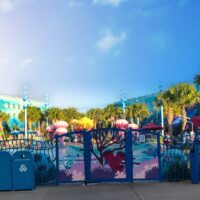 The Deep Blue Pool from the other side of the fence with colorful Nemo decor and palm trees - (the best Disney World hotel for toddlers)