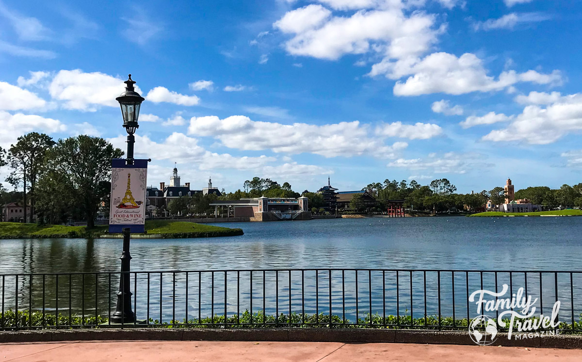 Epcot's World Showcase from the Seven Seas Lagoon with Food and Wine festival sign (one of the annual Epcot events) on a lamppost 