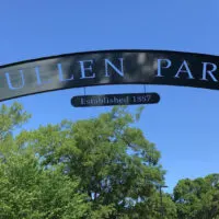 Trees with a sign advertising Pullen Park (one of the best things to do in Raleigh with kids).