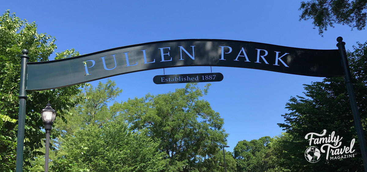 Trees with a sign advertising Pullen Park (one of the best things to do in Raleigh with kids). 
