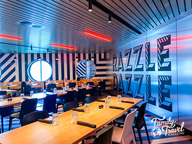 Interior of Razzle Dazzle with tables and chairs and shiny walls