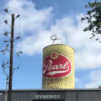 Pearl Brewery can statue on top of building
