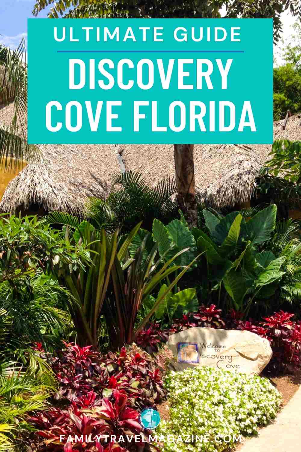 Lush plants and trees at entrance of Discovery Cove with thatched roofs in the background