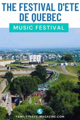 Large FEQ letters on a field with entrance to the festival and crowds of people. 