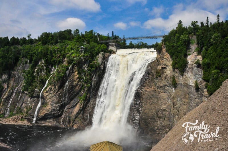 Large waterfall with suspension bridge over it