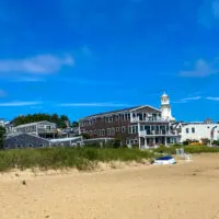 Provincetown shops and restaurants from the back with sand in the foreground - some of the best things to do in Provincetown.
