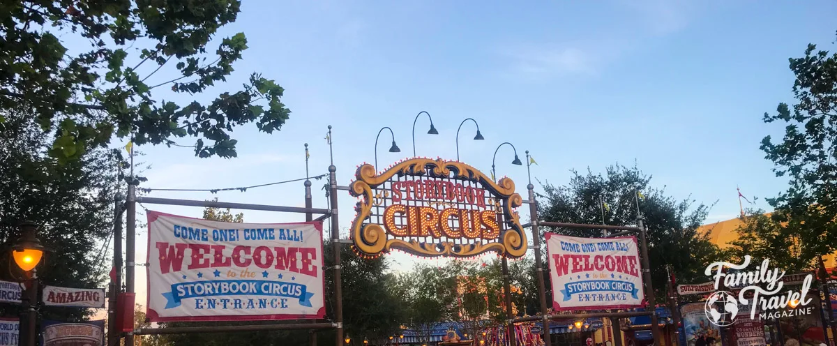 Entrance to Storybook Circus (home to many Magic Kingdom rides with toddlers) with signs and banners advertising the entrance. 