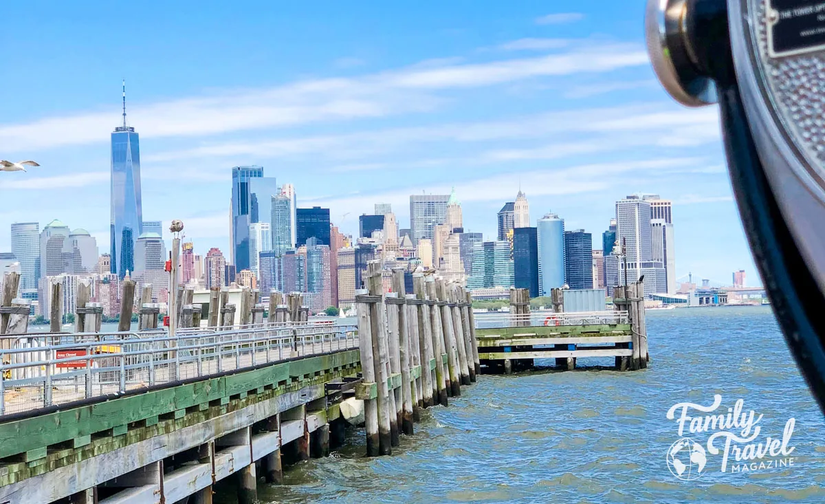 NYC skyline from Liberty Island (one of the best things to do in NYC with kids) with viewfinder in the corner