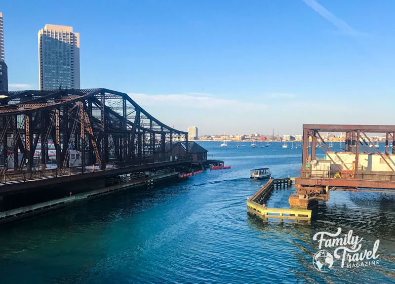 Channel along the Boston Harbor with metal railroad bridge