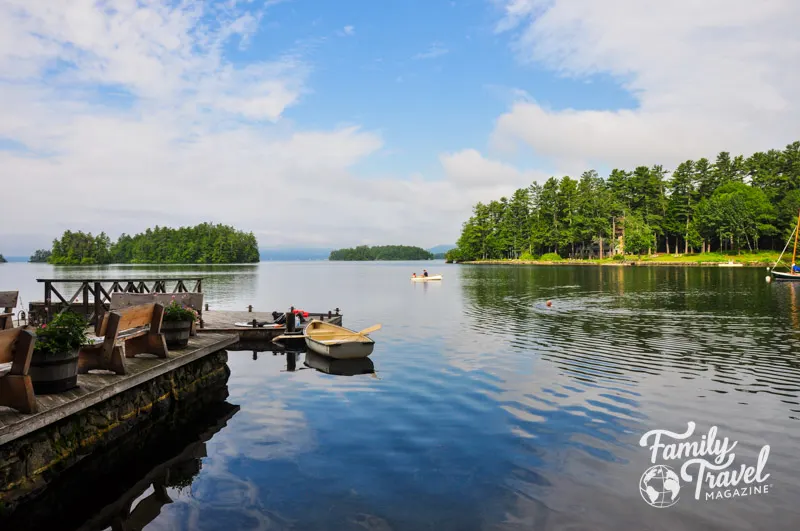 row boat and canoe in lake near pier