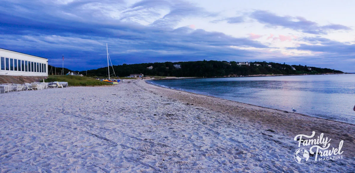 beach with building and stacked chairs at sunset at the Sea Crest Beach Hotel in Falmouth 