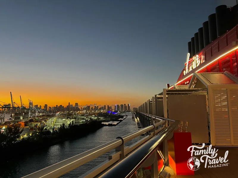 Virgin Voyages ship sailing from Miami at sunset