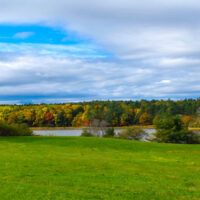 early fall foliage around a small body of water at Wolfe's Neck Farm, one of the best things to do in Freeport, Maine.