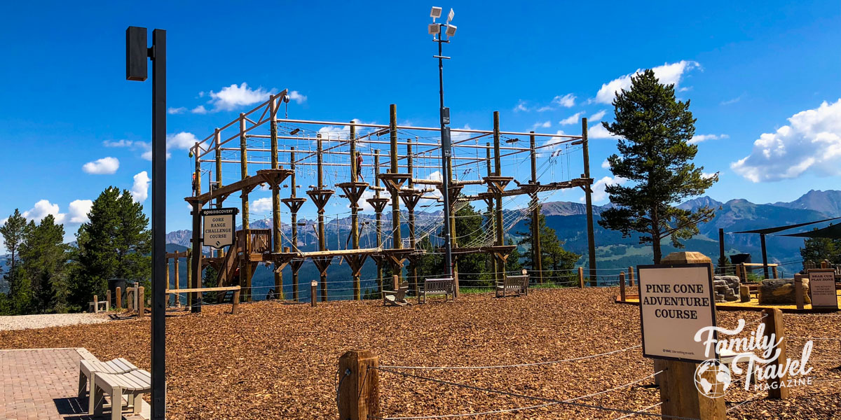 Ropes adventure course with mountains in the backdrop - one of the fun things you can do on family adventure vacations.