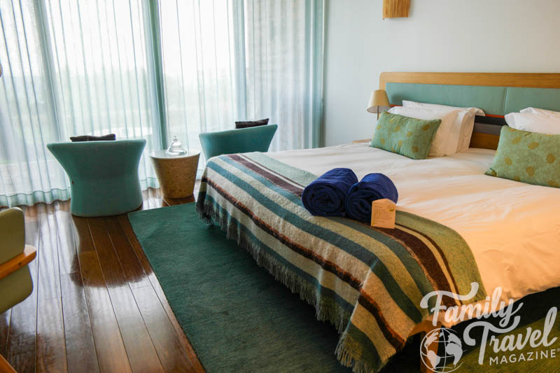 King bed with two chairs in hotel room