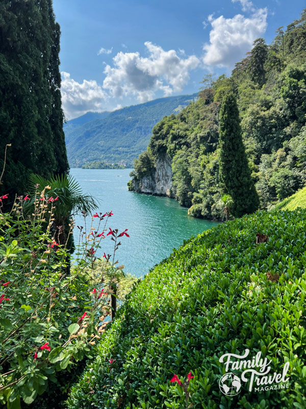 Green shrubs and trees with mountains surrounding the lake