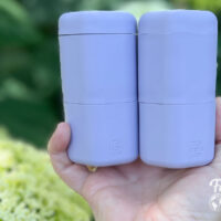 Two purple plastic Cadence toiletry bottles