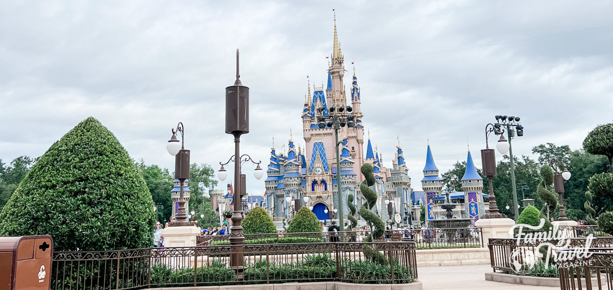 Cinderella Castle with cloudy ski, and topiaries in the foreground