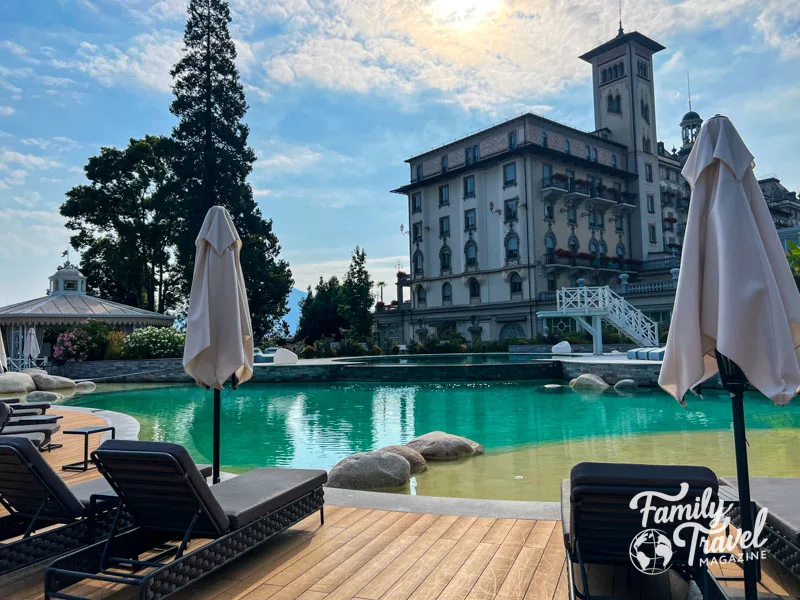 Pool chairs and pool in front of hotel building