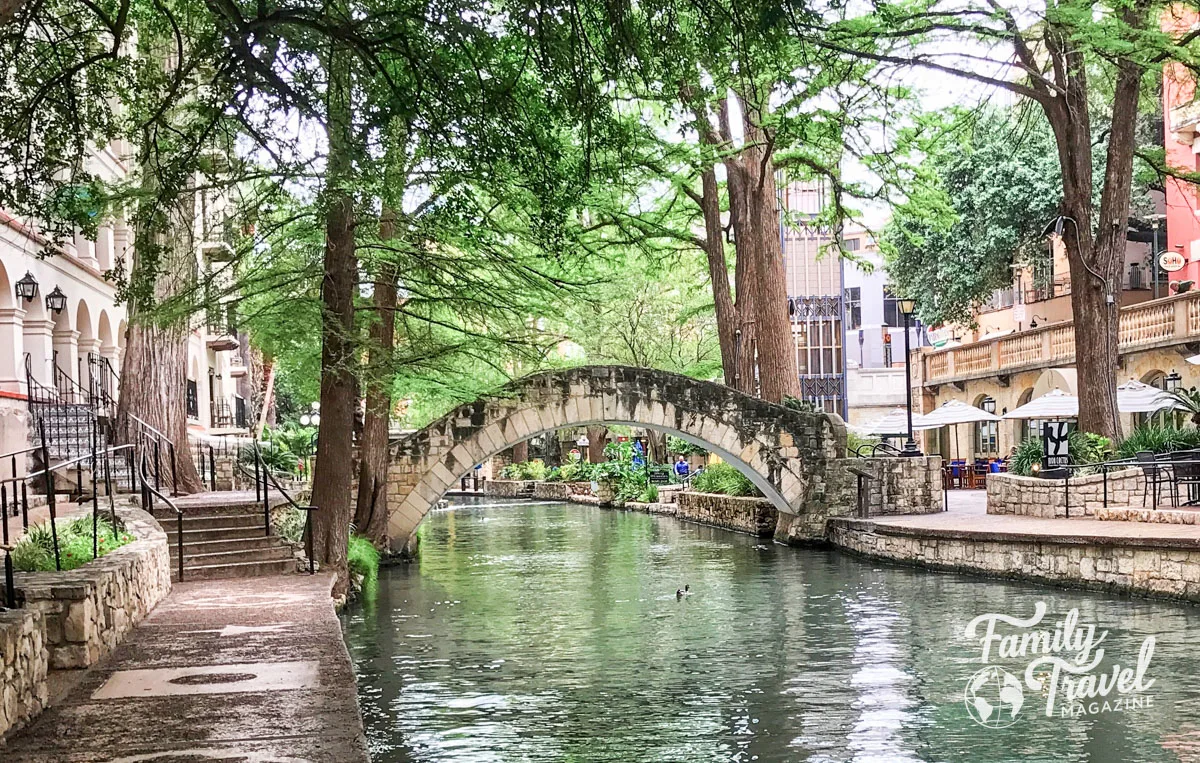 Bridge over River Walk with buildings along the sides