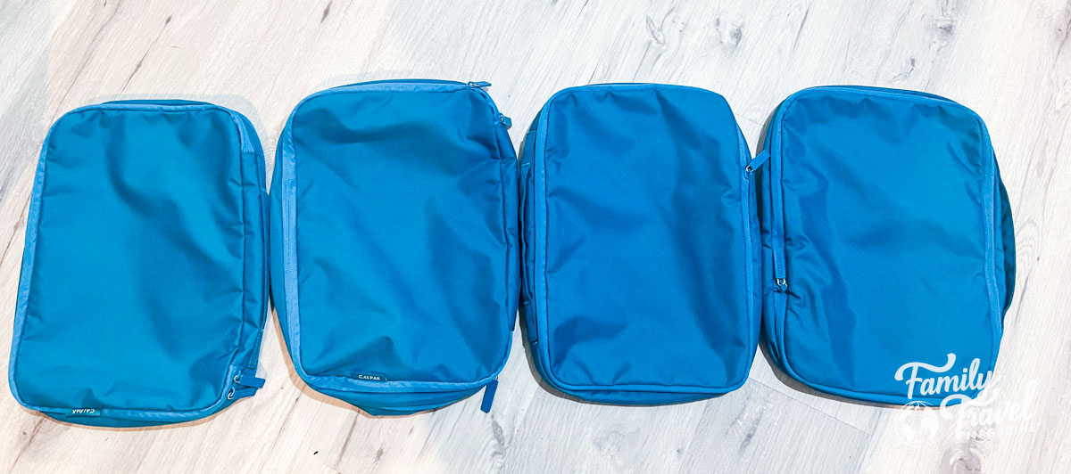 Turquoise blue packing cubes in a row
