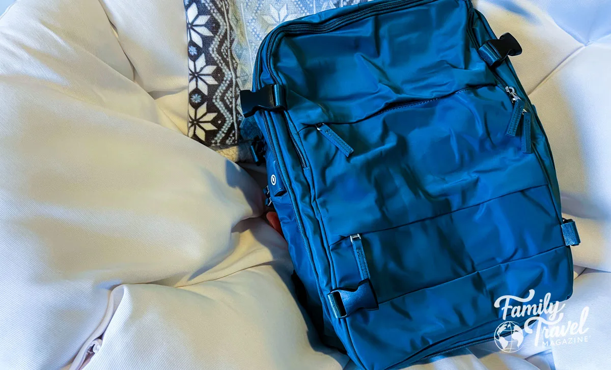 Teal Amazon backpack on a white chair 
