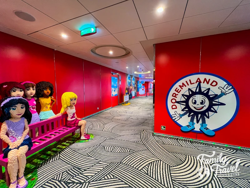Entrance to Doremiland kids' club with life-size LEGO friends sculpture