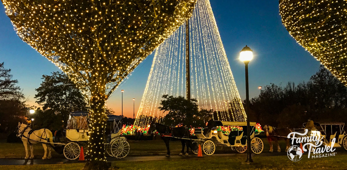 Gaylord Opryland exterior with horse drawn carriages, Christmas lights, and trees. 