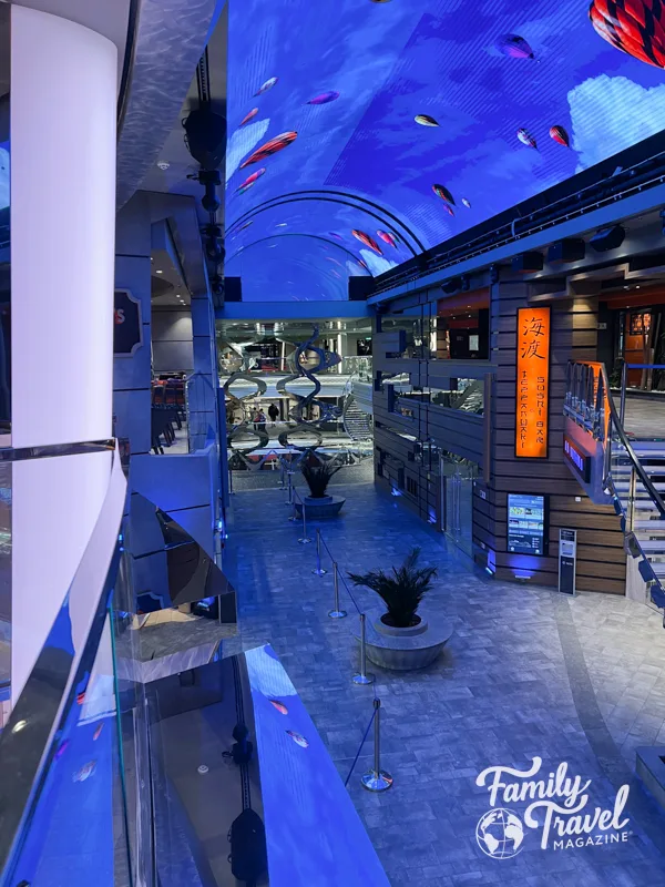 Atrium of MSC Meraviglia with sushi restaurant, and LED ceiling screen with sky and hot air balloons.