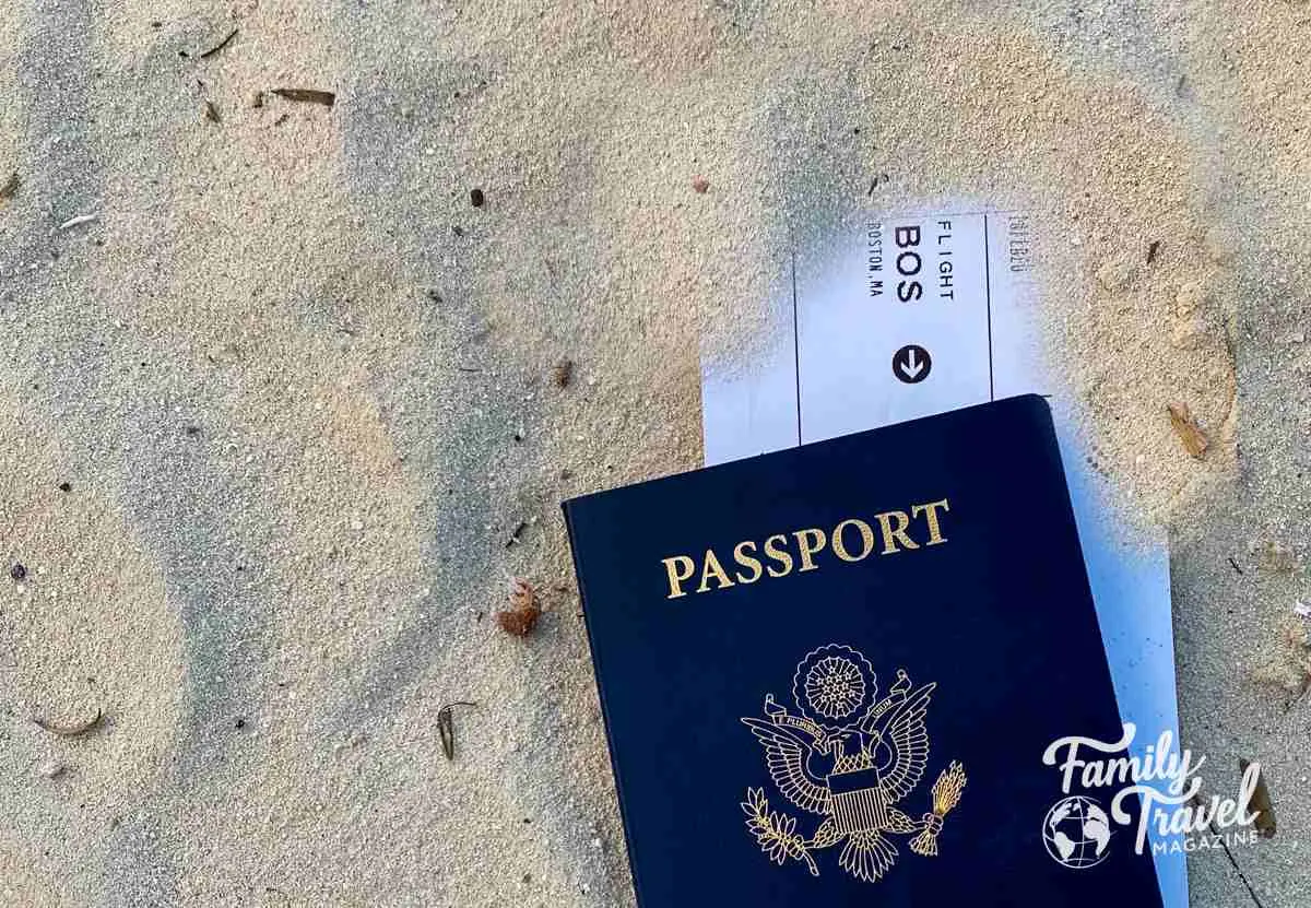 passport and boarding pass in the sand