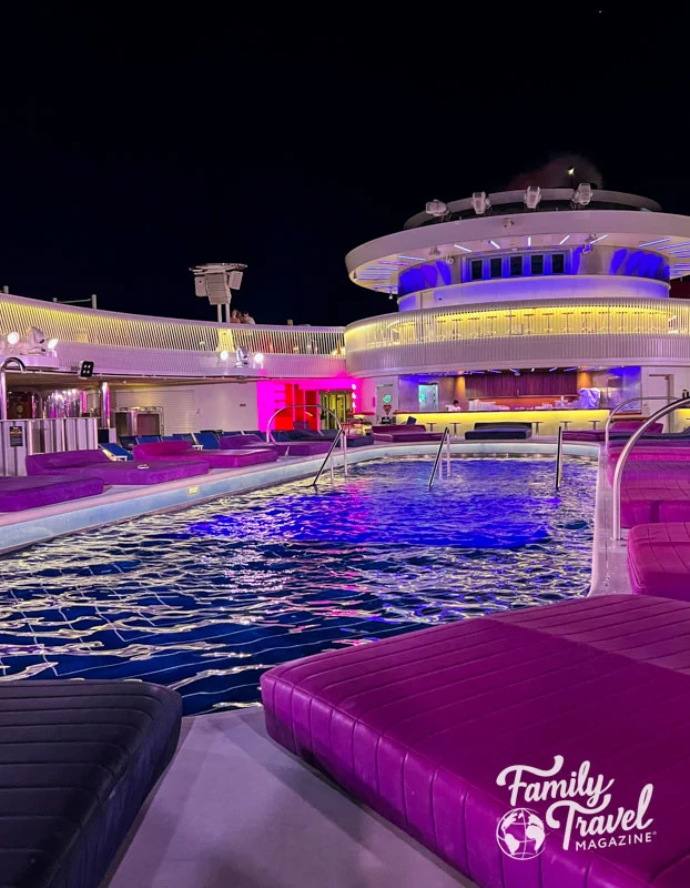 Virgin Voyages Scarlet Lady main pool at night 