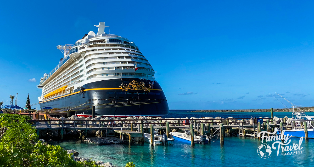 Disney Dream cruise ship docked at Castaway Cay with pier and small boats