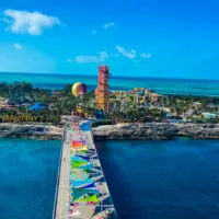 Overview of Perfect Day at Coco Cay with waterslides, beach chairs, hot air balloon and palm trees.