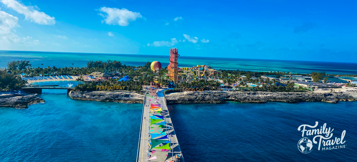 Overview of Perfect Day at Coco Cay with waterslides, beach chairs, hot air balloon and palm trees. 