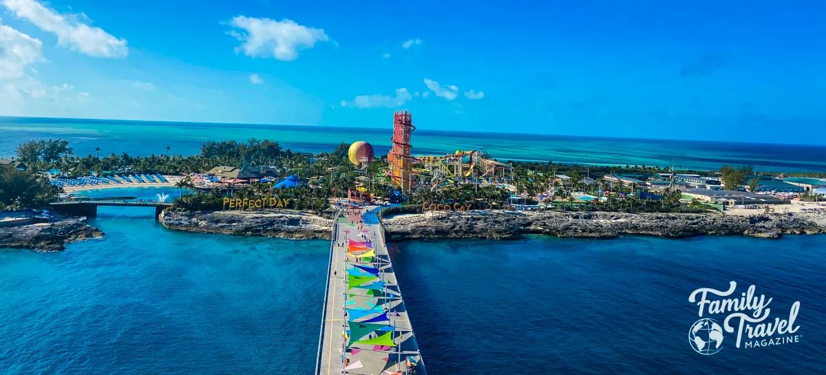 Overview of Perfect Day at Coco Cay with waterslides, beach chairs, hot air balloon and palm trees.