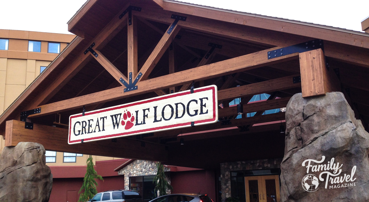 Wooden lodge inspired entrance to the Great Wolf Lodge with a-frame room and large boulders. 