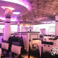 Animator's Palate dining room with paint brush columns and purple hues. along with tables and chairs.