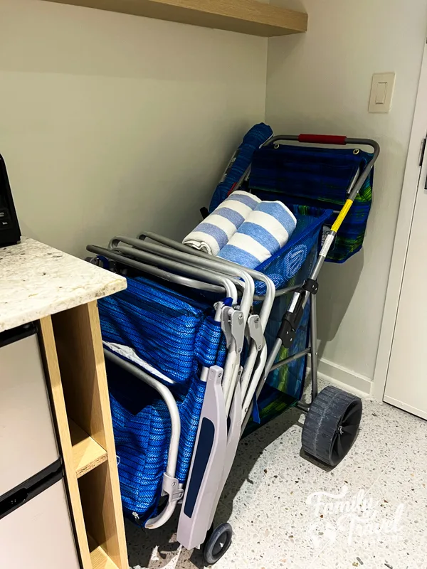 beach cart with towels, umbrella, and beach chairs