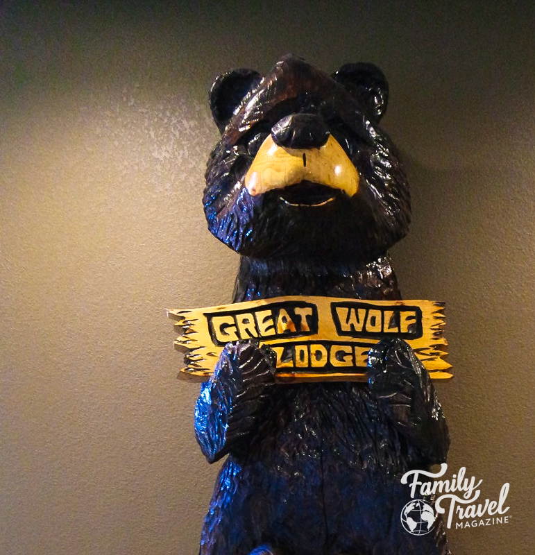Large bear statue holding Great Wolf Lodge sign
