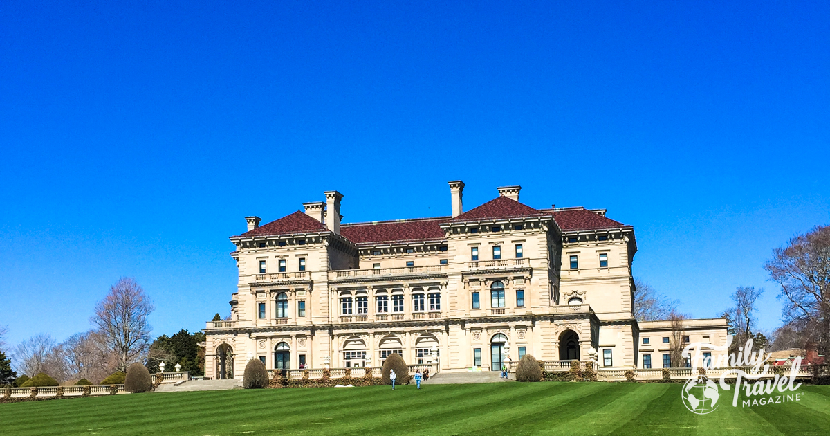 Back of the Breakers mansion with large lawn in front 
