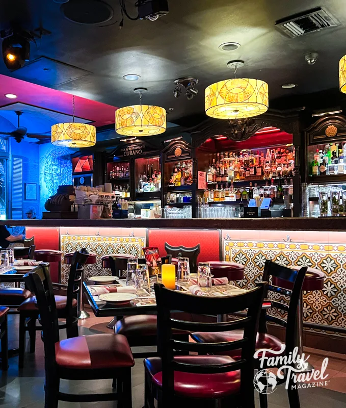 restaurant interior with bar, tables, bright colors and lights