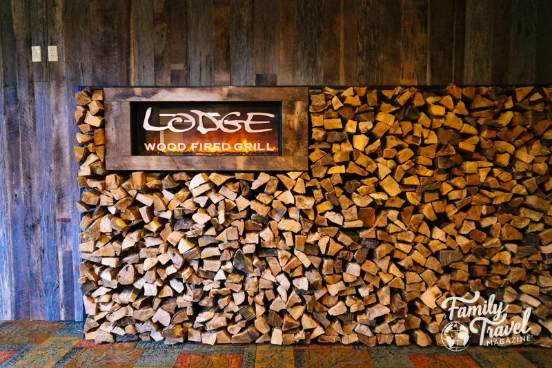 large stack of firewood at entrance of grill