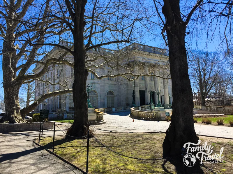 Front side of Marble House mansion with trees in foreground