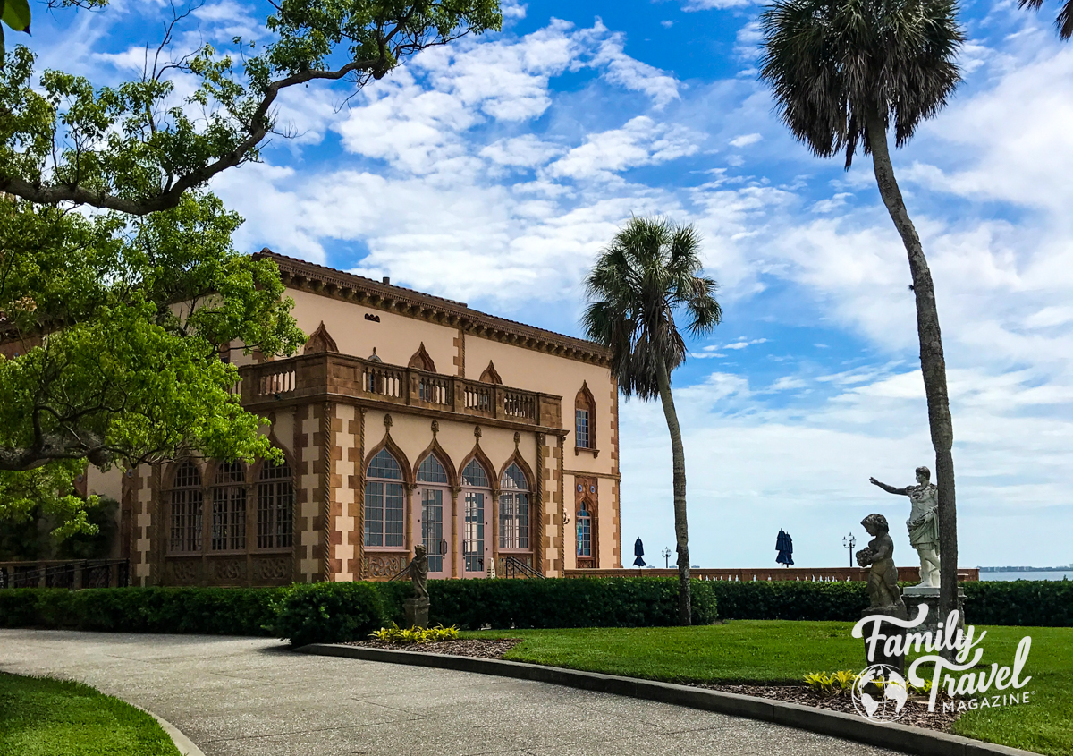 SIde of Ringling mansion with statues and palm trees