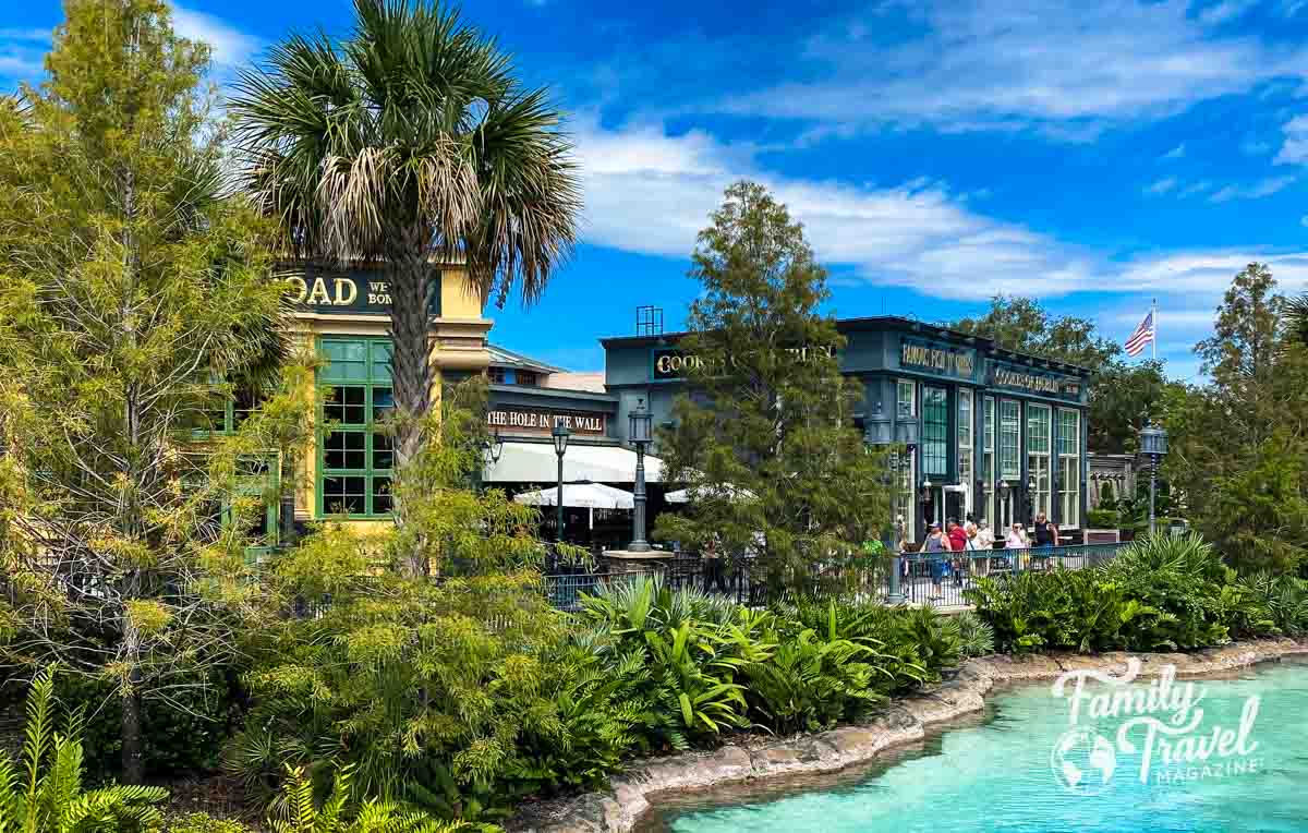 three restaurants along a body of water with palm trees 